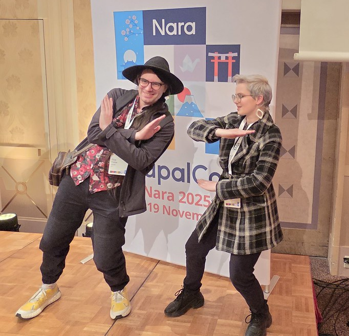 Photo of Rox and Ceri representing the Xequals logo in interpretive gang sign fashion