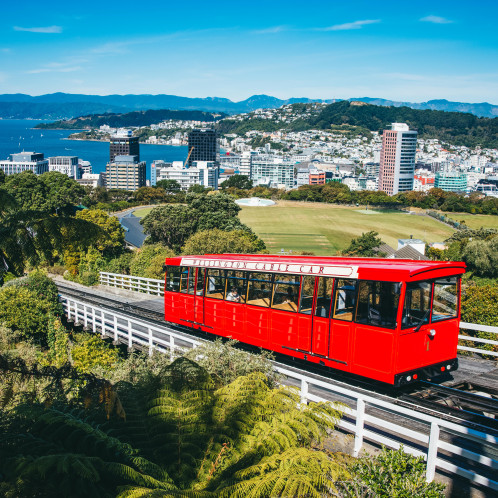 A photo of the Wellington Cable Car. Wellington City is in the background.