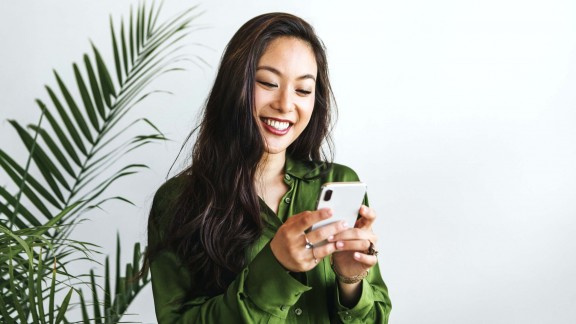 Young woman searches for volunteer opportunities on her phone